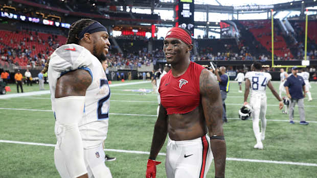 Tennessee Titans running back Derrick Henry (22) talks with Atlanta Falcons wide receiver Julio Jones (11) after their game at Mercedes-Benz Stadium.